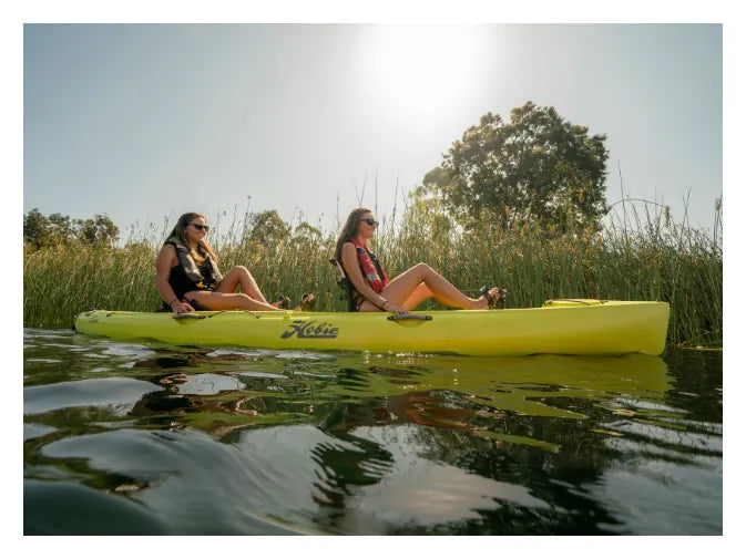 Two people paddling a yellow Hobie kayak
